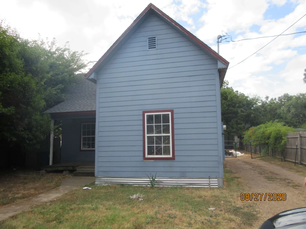 Front of a blue home in Bedford that we bought fast